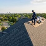 Roofer installing shingle roof